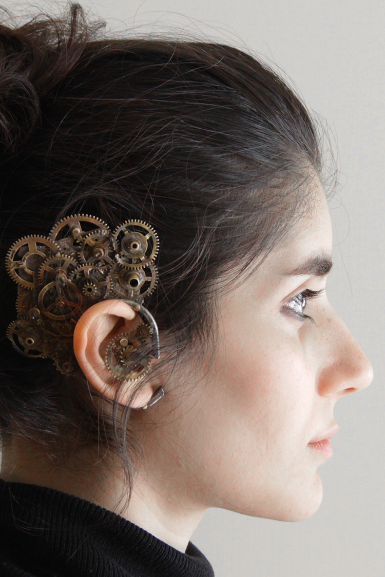 hand fabricated earpiece made of sterling silver and gears of a dismantled clock