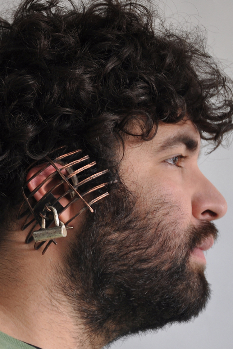 hand fabricated earpiece made of sterling silver and copper