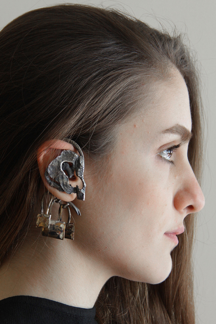 hand fabricated earpiece made of sterling silver and brass