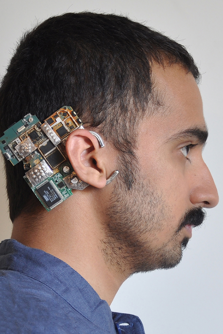 hand fabricated earpiece made of sterling silver and pieces of a circuit board.